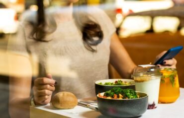 woman in white tank top holding spoon