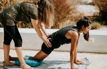 woman in black tank top and black shorts kneeling on mat