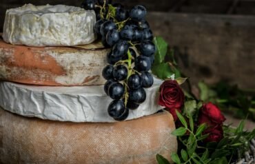 grape fruit hanging near red rose