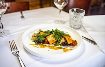 a white plate topped with food on top of a table